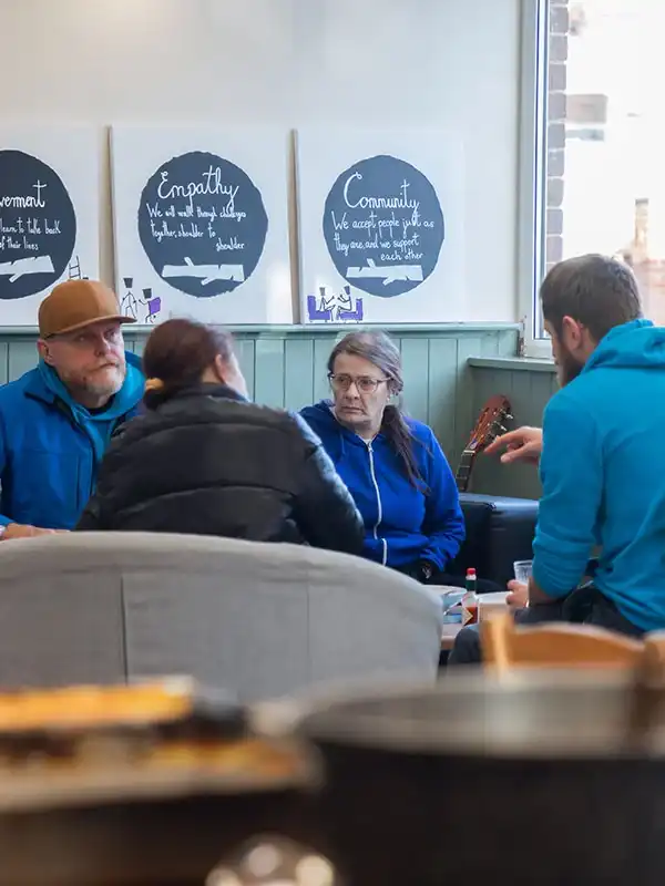 A group of Handcrafted trainees having a discussion in a cafe