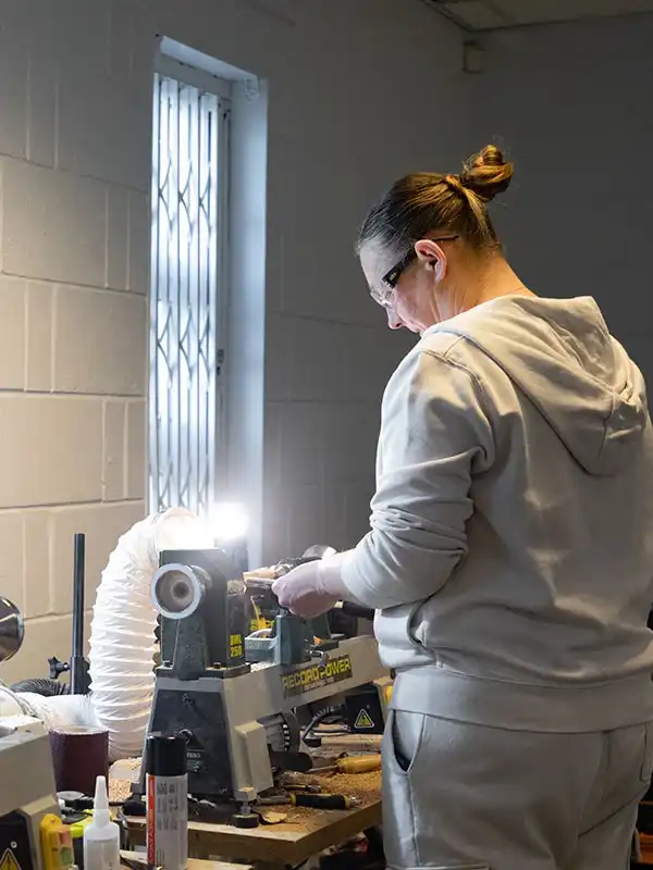 A Handcrafted trainee operating a lathe