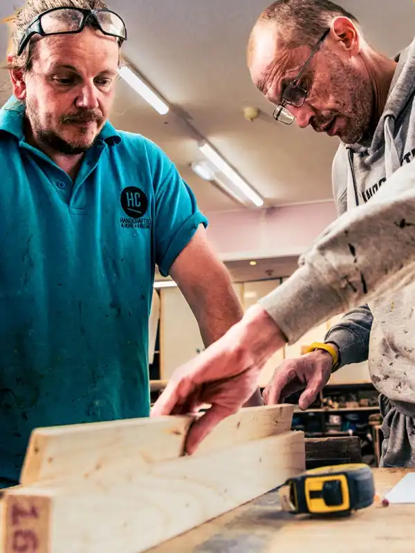 Two men working on a Handcrafted woodworking project