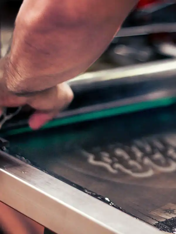 A man screenprinting a Handcrafted logo