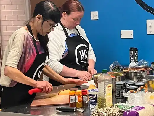 Two women preparing food in the Handcrafted kitchen