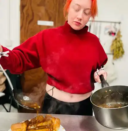 A trainee serving a meal in the Handcrafted kitchen