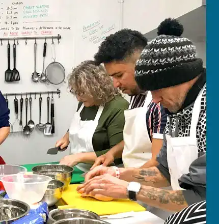 Trainees preparing food in the Handcrafted kitchen