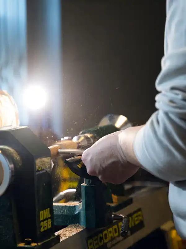 Handcrafted trainee working on a woodwork lathe